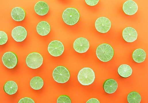 Sliced of  limes on wood background,top view