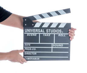 Woman holding movie production clapper board isolated on a white background
