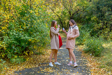 Fototapeta premium Pregnant woman walking in a park