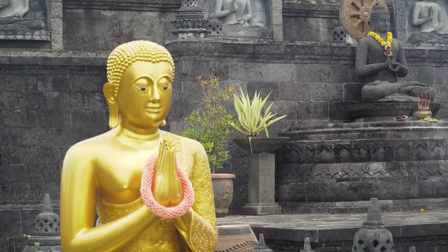 Statue of the Buddhist God Buddha in the Buddhist temple Brahma Vihara Arama with statues of the gods on Bali island, Indonesia. Bali Architecture, Ancient design. Travel concept.