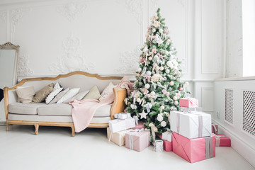 beautiful modern design of the room in delicate light colors decorated with Christmas tree and decorative elements