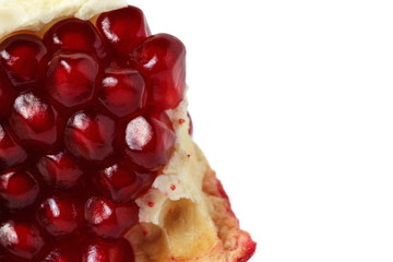 grains of pomegranate macro on white isolated background