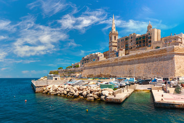 Valletta Skyline with fortress wall, boat pier and St. Paul's Anglican Pro-Cathedral, Valletta, Capital city of Malta. View from the sea