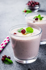 Cranberry detox smoothie on concrete or stone background. Selective focus, copy space, close up. 