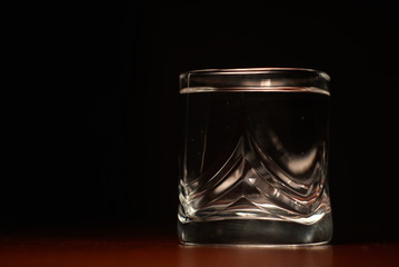 a glass of water on a black background