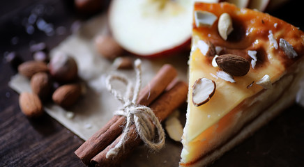 Fototapeta premium Pie with cinnamon and apples on a wooden table. Fresh pastry wit