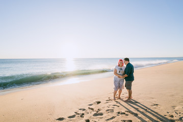 Couple on a beach at sunset in Portugal