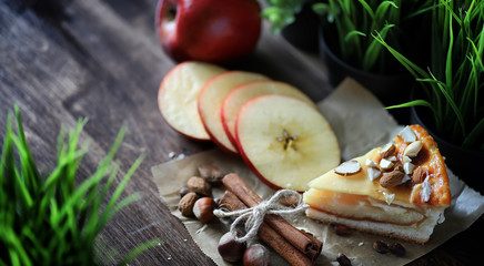 Pie with cinnamon and apples on a wooden table. Fresh pastry wit
