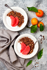 Healthy winter breakfast. Greek yogurt bowl with chocolate gingerbread granola and grapefruit. Top view, flat lay, overhead