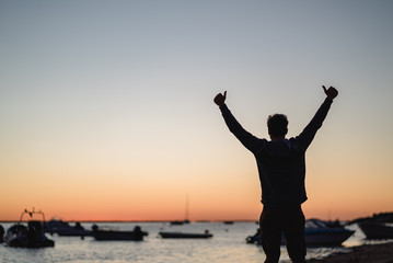 Fototapeta premium Man watching the sunrise in Portugal