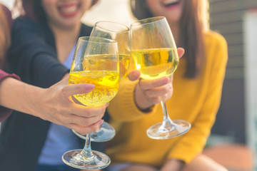 Outdoor shot of young people toasting drinks at a rooftop party. Young asian girl friends hanging out with drinks. Holiday celebration festive party. Teenage lifestyle party. Freedom and fun outdoor.