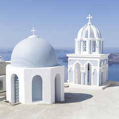 Fototapeta na wymiar Greek white and blue dome ortodox church in Firostefani on Santorini island, Greece