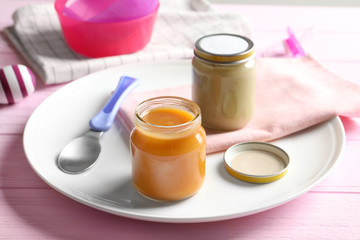 Composition with jars of healthy baby food on wooden table