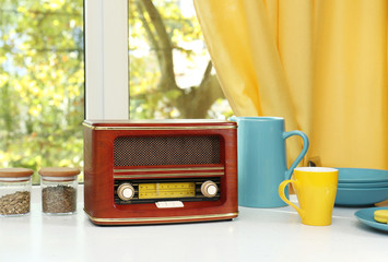 Stylish radio receiver on kitchen table