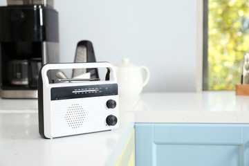 Stylish radio receiver on kitchen table