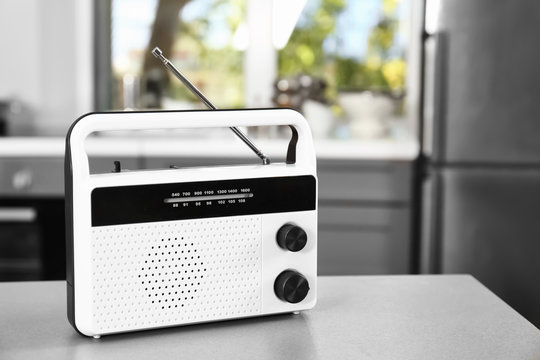 Stylish radio receiver on kitchen table
