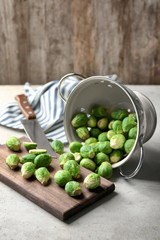 Colander with fresh scattered Brussels sprouts on table © Africa Studio