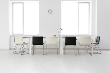 Modern office interior with large table and chairs