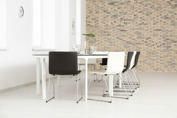 Modern office interior with large table and chairs