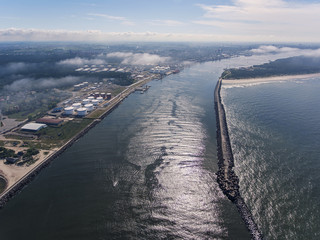 Aerial view over Klaipeda pier entrance to the Baltic sea in Lithuania, during summer time.	