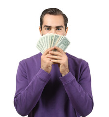 Young man with dollar bills on white background