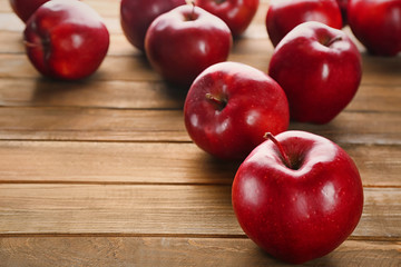 Ripe red apples on wooden background