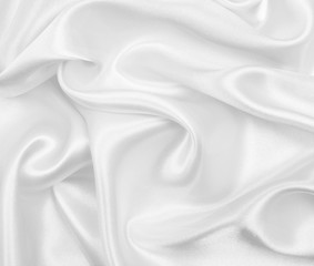 Smooth elegant white silk or satin luxury cloth texture as wedding background. Luxurious Christmas background or New Year background design