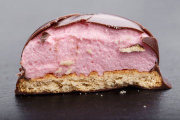 round chocolate candy on a black slate board. horizontal image