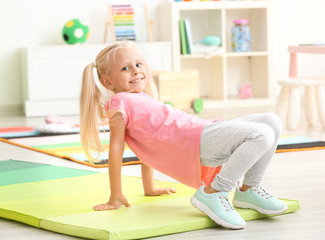 Cute little girl playing in kindergarten