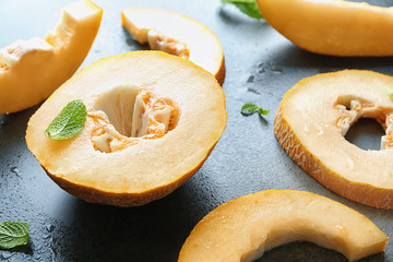 Yummy cut melon on grey background