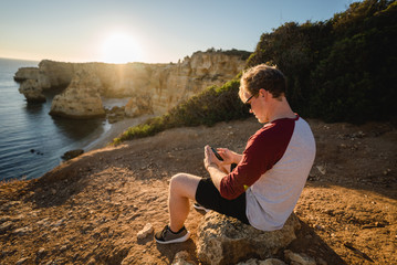 Sitting on a cliff in Portugal