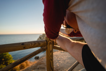 Man stretching at sunset on a cliff