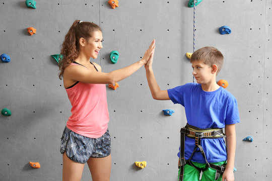 Boy and instructor in climbing gym