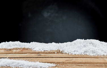 Winter card with snow on a wooden rustic board