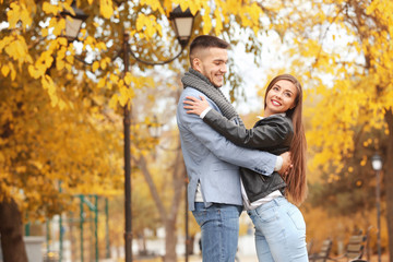 Young couple in park on autumn day