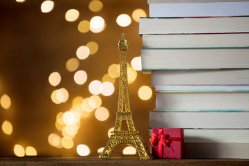Christmas gift with Eiffel tower toy and pile of books