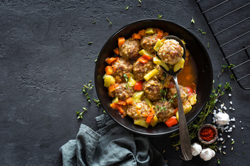 Meatballs in sauce with vegetables, top view