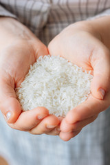 Woman hands holding a white rice.