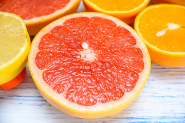 Naklejka na ściany i meble orange lemon grapefruit on a light wooden background background 