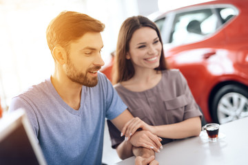 A young family came to the car showroom to choose a new car.