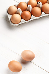 Raw, brown, chicken eggs on wooden white boards. with space for text
