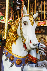 Fototapeta na wymiar City colorful traditional french carousel for children, horse for riding