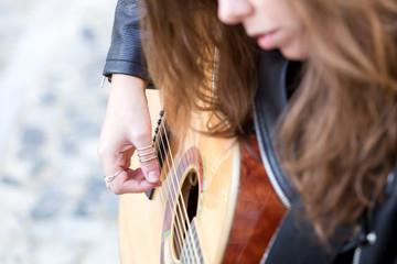 Closeup Picture of Young Woman Playing Guitar