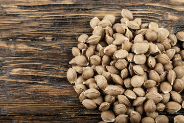 good for health, apricot pits on wooden background with spase for text. use in food and cosmetics. top view