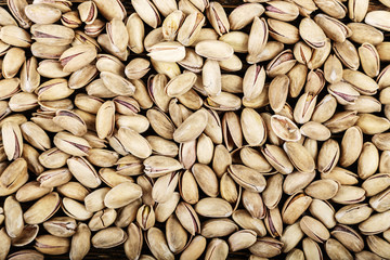 tasty pistachios lying on the table,  space for text