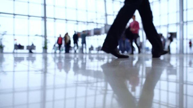 People walk inside a bright, modern building
