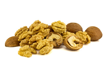 light yellow walnut core close-up with peel and leaves stacked in a isolate composition on a white background