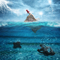 Doll sinking on top of a book