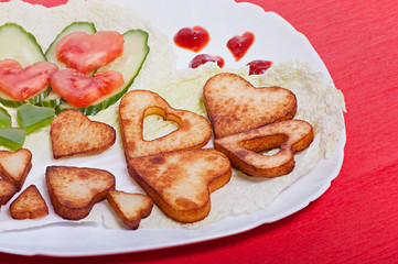 French fries and vegetables cut into the heart. Valentine's Day