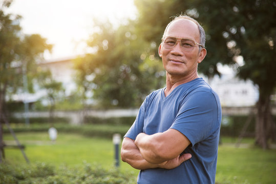 Asian Senior male posing with arms crossed.
